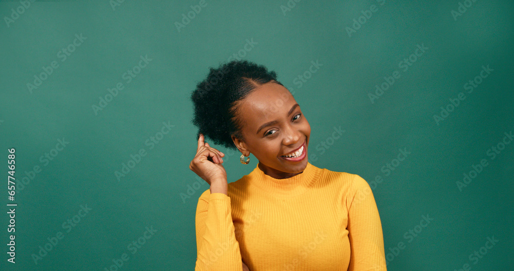 Beautiful young woman flirts and twirls natural afro hair, studio background Beautiful young woman flirts and twirls natural afro hair, studio background