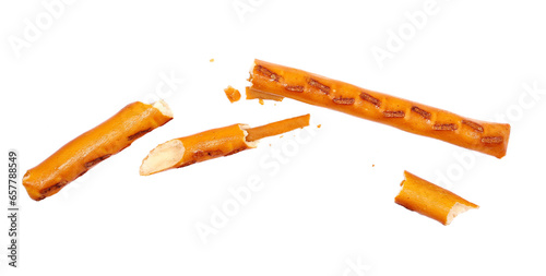 Broken salty cracker pretzel sticks in fly, stuffed with peanuts and crumbs isolated on white  photo