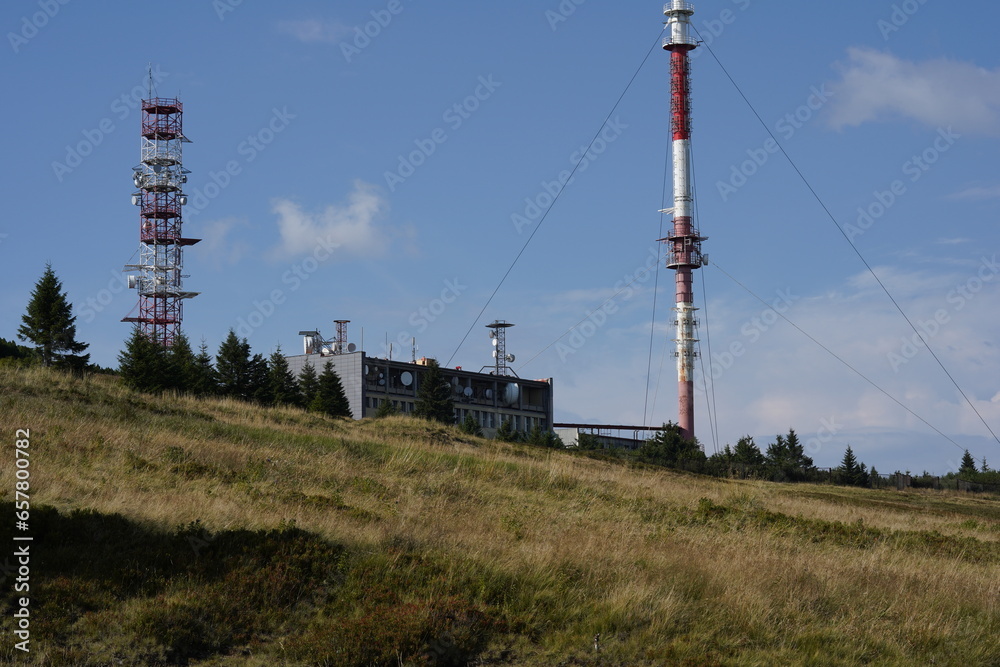 The Krížava transmitter is a radio and television transmitter on the hill Mala Fatra in Slovakia. Next is a free-standing steel telecommunications tower as well as a large service building. - obrazy, fototapety, plakaty 