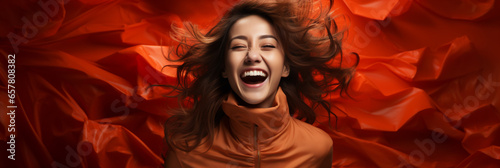 Photo of a Happy Girl Laughing on a Red Background