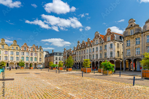 Arras cityscape with Flemish-Baroque-style townhouses buildings on La Grand Place square in old town center, blue sky in summer day, Pas-de-Calais department, Hauts-de-France Region, Northern France photo