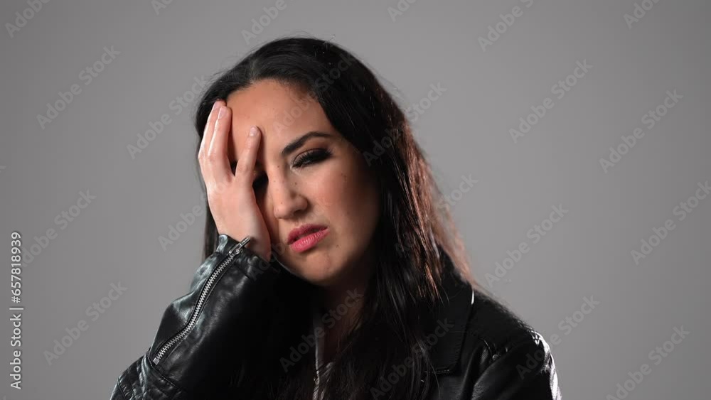 Young woman has problems or is suffering from headache - studio photography Young woman has problems or is suffering from headache - studio photography