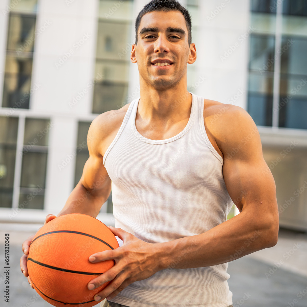 Portrait of strong athlete man hold basketball ball wear white a-shirt Portrait of strong athlete man hold basketball ball wear white a-shirt