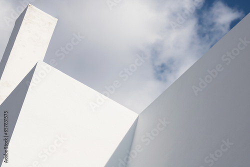 Abstract architecture. Close up of a white facade with overcast sky