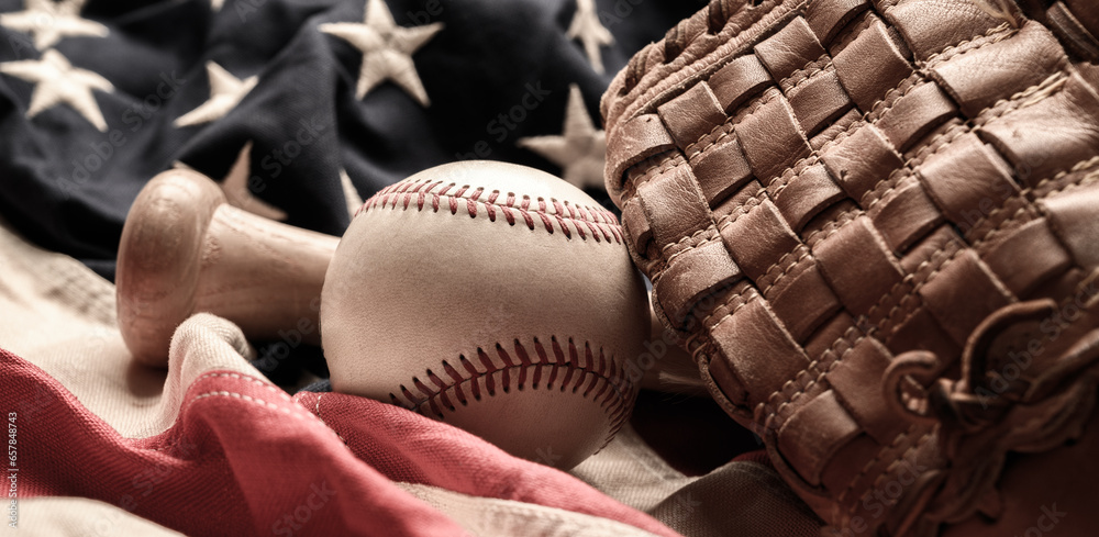 A baseball glove, bat and ball on American flag. The national pastime - obrazy, fototapety, plakaty 