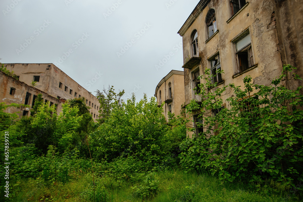 Old ruins of Soviet Ghost town overgrown by vegetation