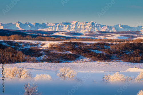 Bow River Valley in fog with the Rocky Mountains in the background, Calgary, Alberta