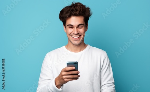Cool Young Smiling Man Making an "OK" Gesture on Smartphone © bomoge.pl