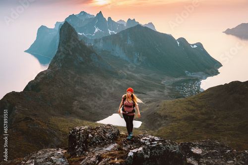 Woman hiking solo in Norway travel outdoor healthy lifestyle active girl with backpack exploring mountains success motivation concept female hiker on summer vacations © EVERST