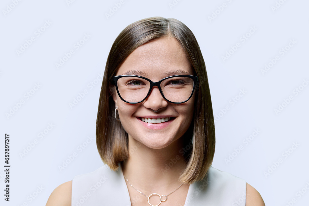 Headshot portrait of young beautiful woman in glasses, on white studio background