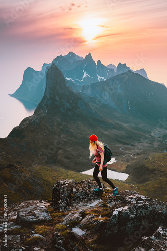 Traveler woman hiking alone on a trail in Norway outdoor travel summer vacations healthy lifestyle active girl with backpack exploring mountains success motivation concept