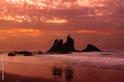 fiery summer sunset behind the typical rocks of benijio beach in the north east of tenerife island