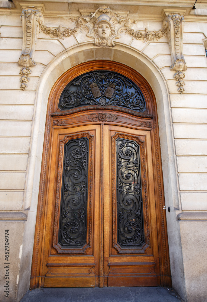 Old ornate door in Paris - typical old apartment buildiing.