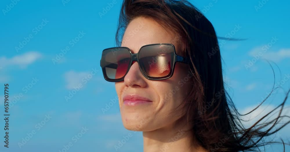 Close up portrait of beautiful woman enjoying peaceful sunset exploring spirituality praying contemplating journey with wind blowing hair Close up portrait of beautiful woman enjoying peaceful sunset exploring spirituality praying contemplating journey with wind blowing hair