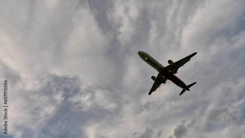 Jet plane landing in silhouette. Tracking shot of airplane landing. Modern business jet flying overhead. 4K Airplane impressive landing flying overhead. Jet plane landing in silhouette. Tracking shot of airplane landing. Modern business jet flying overhead. 4K Airplane impressive landing flying overhead.