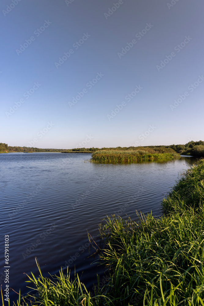 a wide river in sunny weather in early autumn