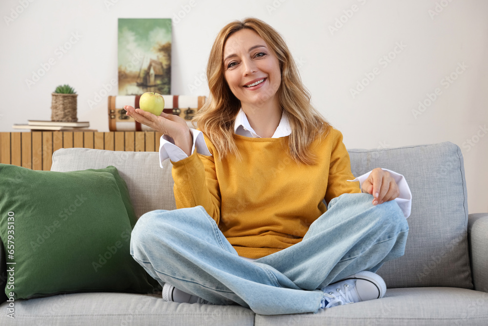 Mature woman with tasty apple at home Mature woman with tasty apple at home