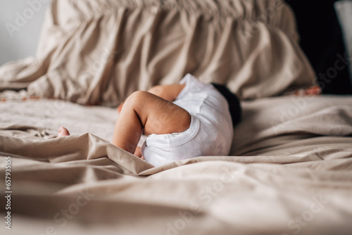 newborn lying on the bed