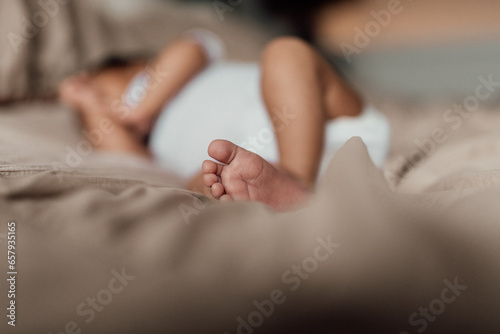newborn lying on the bed