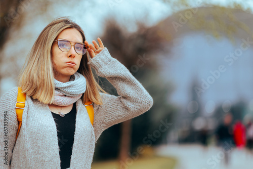Woman Wearing Glasses Checking something in the Distance. Myopic girl having vision problems with he old pair 
