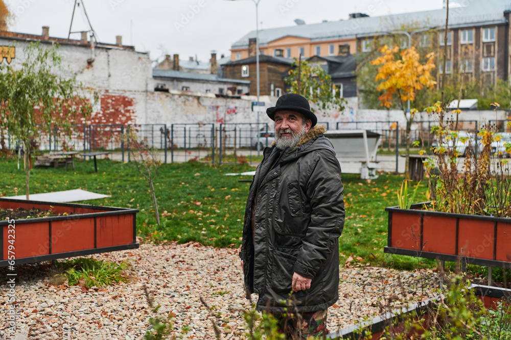 In the historic city of Riga, a bearded elderly man passionately explains the traditional symbolism of Halloween, connecting generations through cultural heritage and folklore. In the historic city of Riga, a bearded elderly man passionately explains the traditional symbolism of Halloween, connecting generations through cultural heritage and folklore.