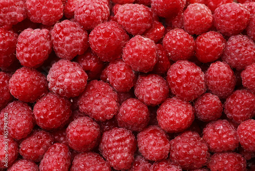 Heap of tasty ripe raspberries as background, top view
