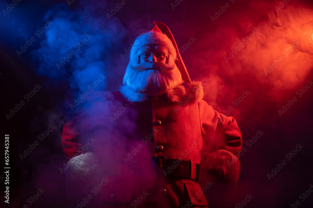 Santa Claus portrait in blue red neon light and smoke. 
