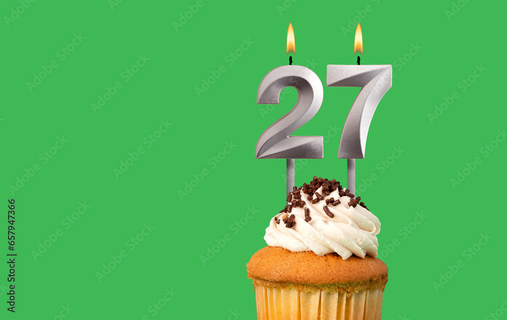 Birthday with number 27 candle and cupcake - Anniversary card on green color background Birthday with number 27 candle and cupcake - Anniversary card on green color background