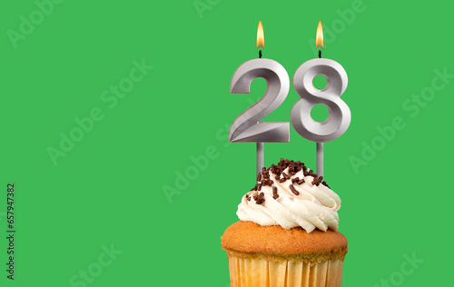 Birthday card with candle number 28 - Cupcake on green background