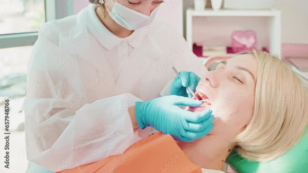 Dentist woman checking woman's teetn using dental mirror in dentistry. Dentist woman checking woman's teetn using dental mirror in dentistry.