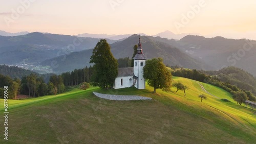 Aerial view of St. Thomas church (Cerkev Sveti Tomaz) on top of a hill, sunrise, Skofja Loka, Slovenia