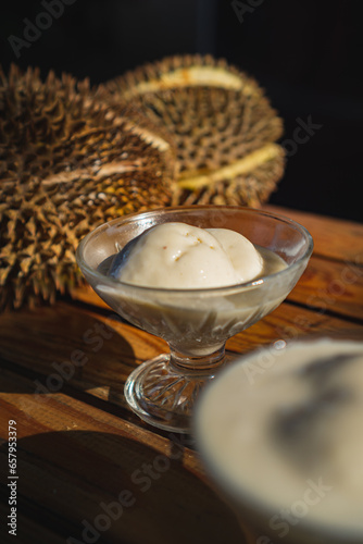 ice cream flavor durian, with a durian fruit as a background, sweet and custardy flavor photo