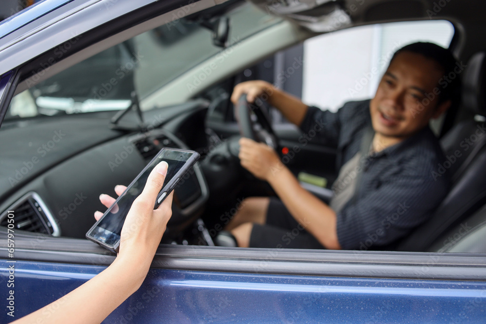 Male online taxi driver picking up passenger 