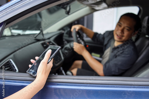 Male online taxi driver picking up passenger  © Gatot