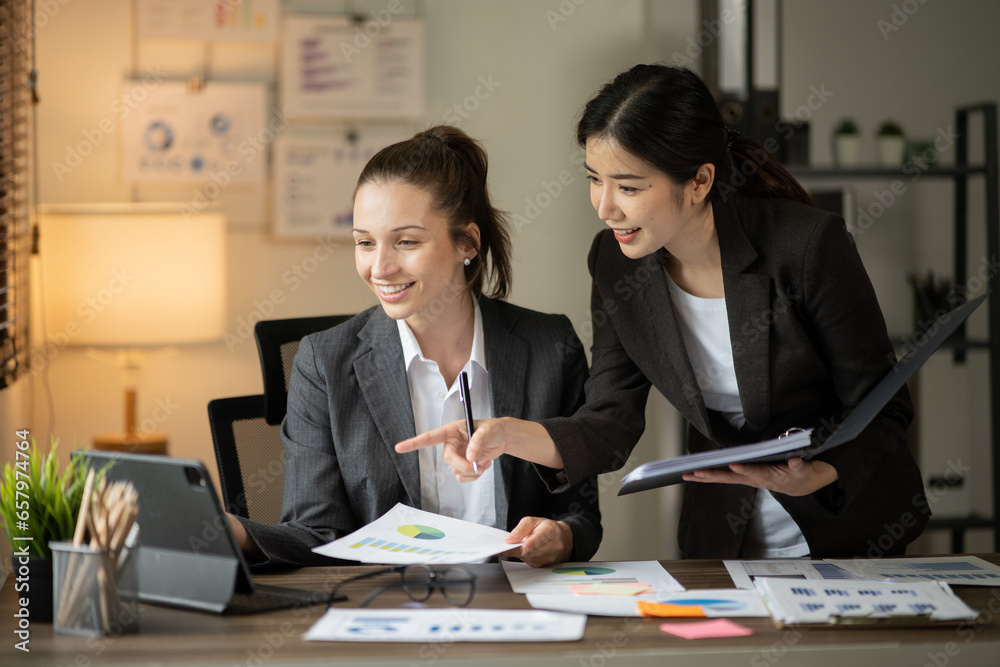 Group of asian business people working, discussing new projects together, having fun at the office.