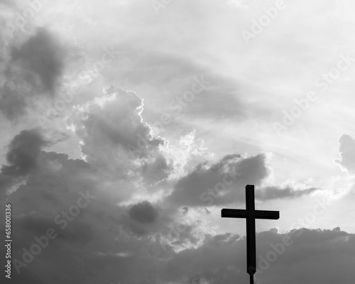 A christian cross under the dark sky