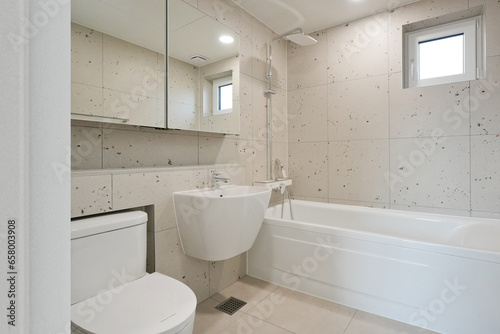 A bathroom with square tiles appears visually larger