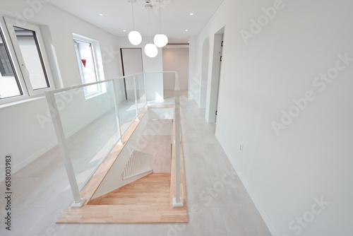 This is a house with stairs leading down to the basement installed in the middle of the living room