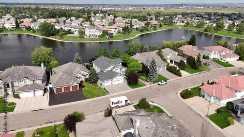 Aerial footage of Briarwood, Saskatoon, SK, highlighting its elegant homes, winding streets, and green parks. A tranquil suburban escape, perfect for real estate visuals. photo