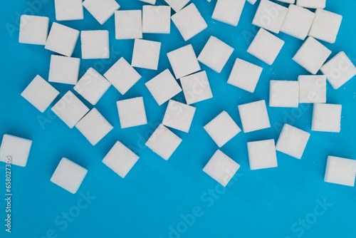 Fototapeta Naklejka Na Ścianę i Meble -  Sugar cubes on blue background