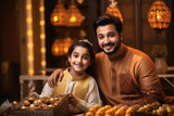 Young indian muslim man celebrating diwali festival with his daughter