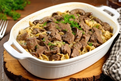 beef stroganoff with egg noodles in square dish