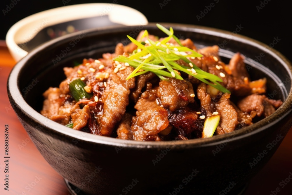 close-up of cooked bulgogi in a traditional korean bowl