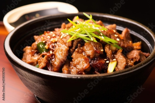 close-up of cooked bulgogi in a traditional korean bowl