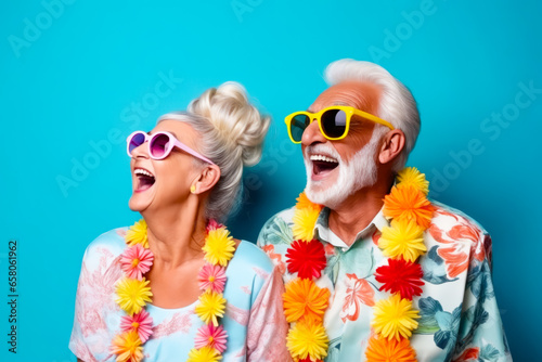Man and woman wearing sunglasses and leis with flowers.