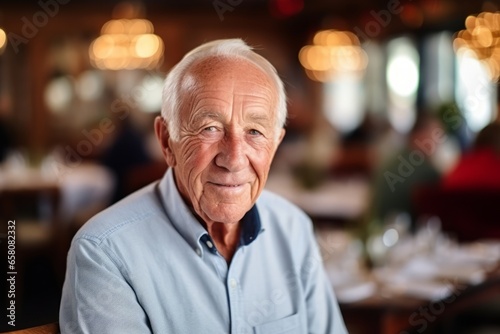Portrait of a happy senior man at restaurant, shallow depth of field