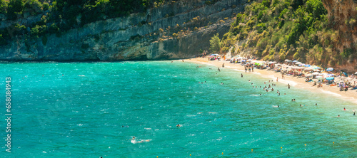 Panorama of Makris Gialos beach in Zakynthos in Greece. People enjoying vacations.
