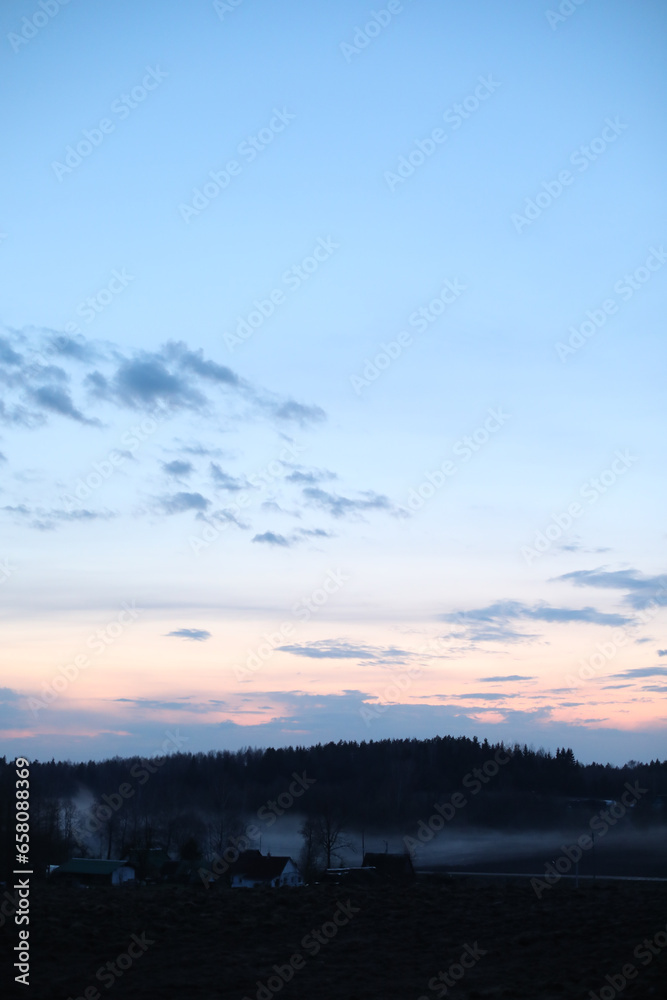 Obraz premium Glorious sunset over grassy rural landscape . Amazing panoramic sunset sky with colorful clouds. Gradient color. Sky texture, abstract nature background