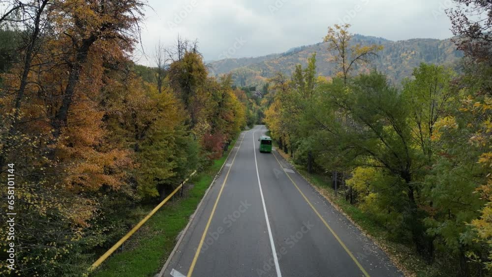 Almaty, Kazakhstan - 10.02.2023 : Paved road in a mountainous area with different vegetation