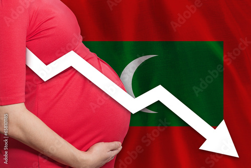 Pregnant woman on flag of Maldives islands background. Falling fertility rate